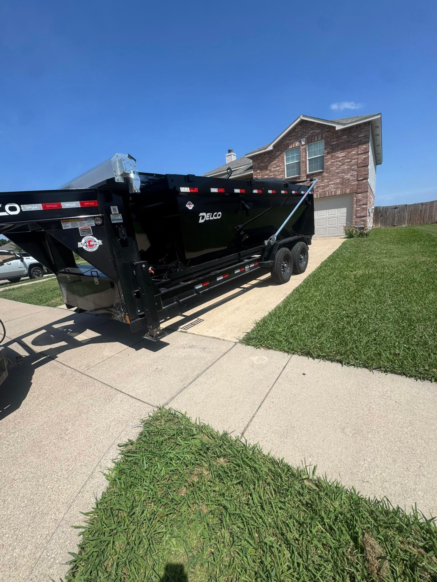 Roll-off dumpster trailer placed on a residential driveway in Cleburne, TX