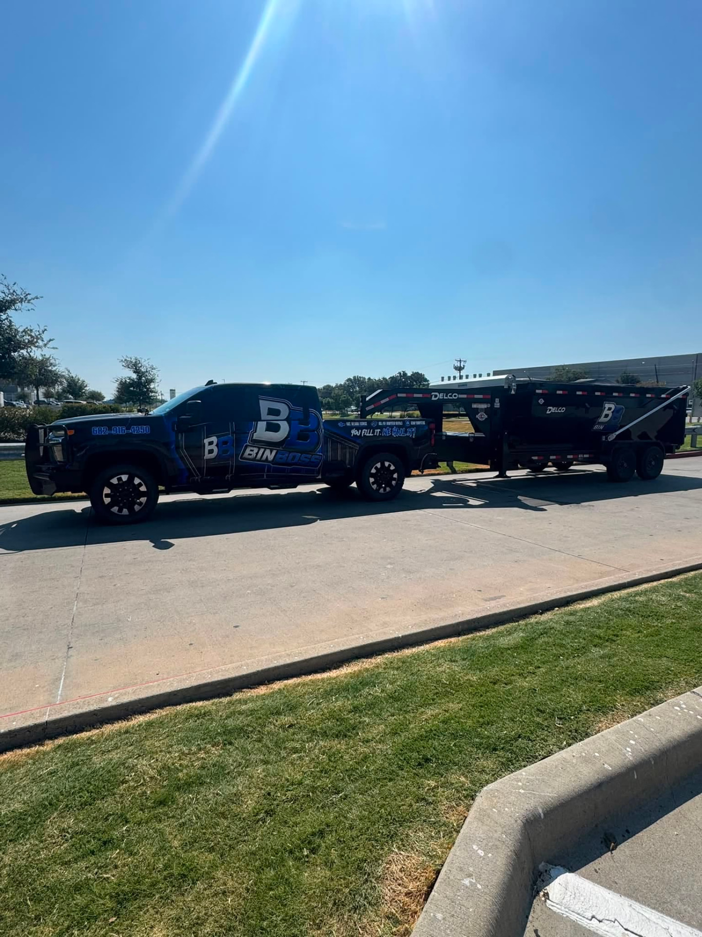BinBoss DFW rig hauling a roll-off dumpster through the DFW metroplex