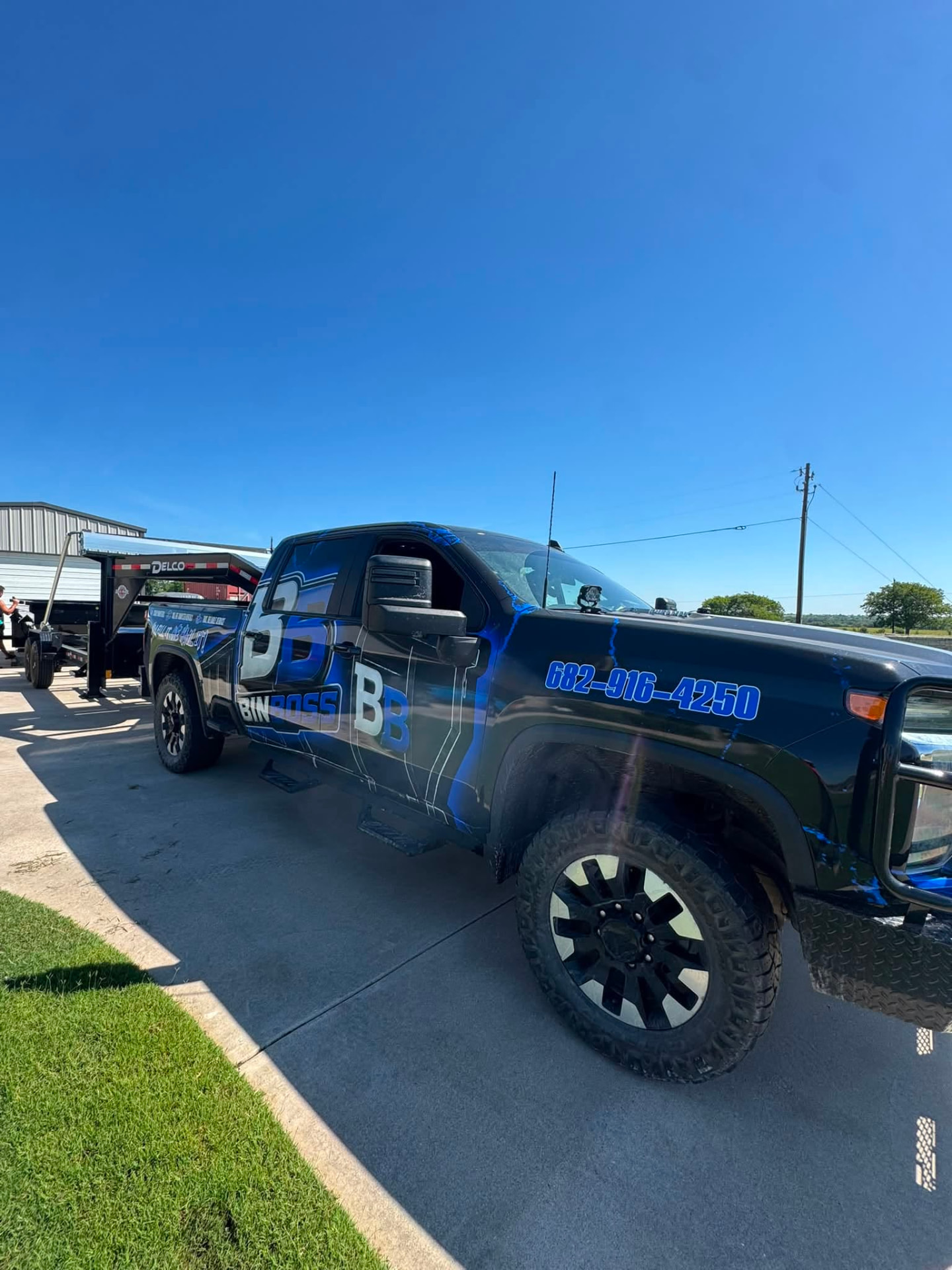 BinBoss DFW wrapped truck parked at the yard in Cleburne, Texas